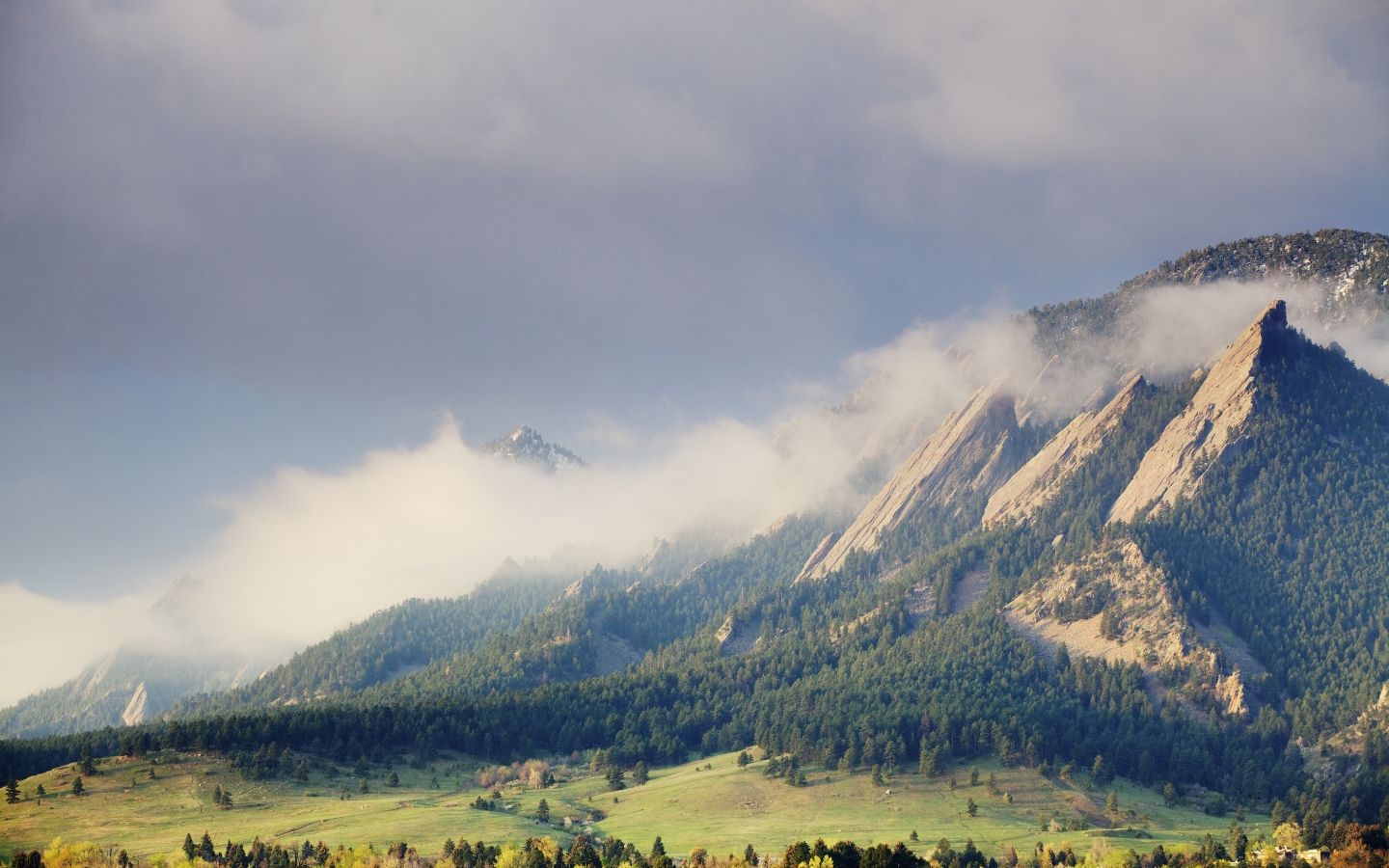Mountain landscape with dramatic clouds and golden sunlight